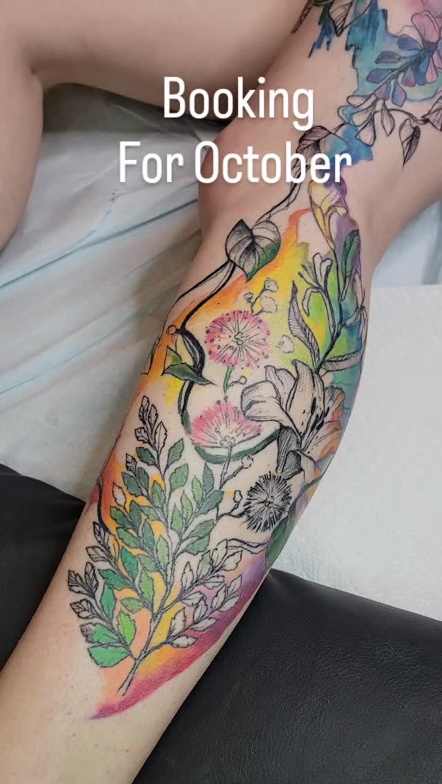 Watercolor floral forearm piece with vivid botanicals