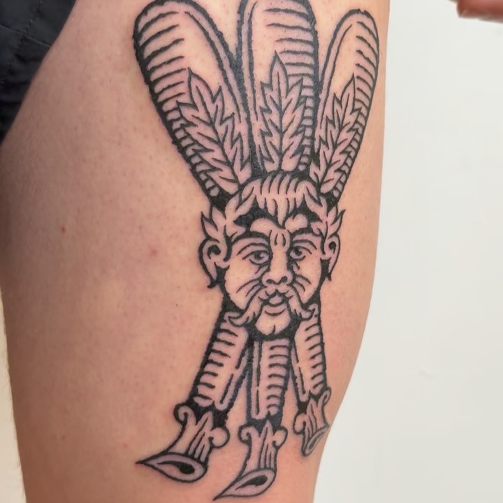 Bold linework, playing-card-inspired figure with elongated ears and leafy crown