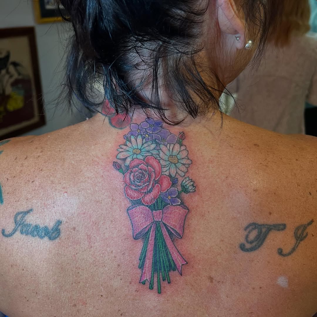 Pastel floral bouquet with pink ribbon on upper back