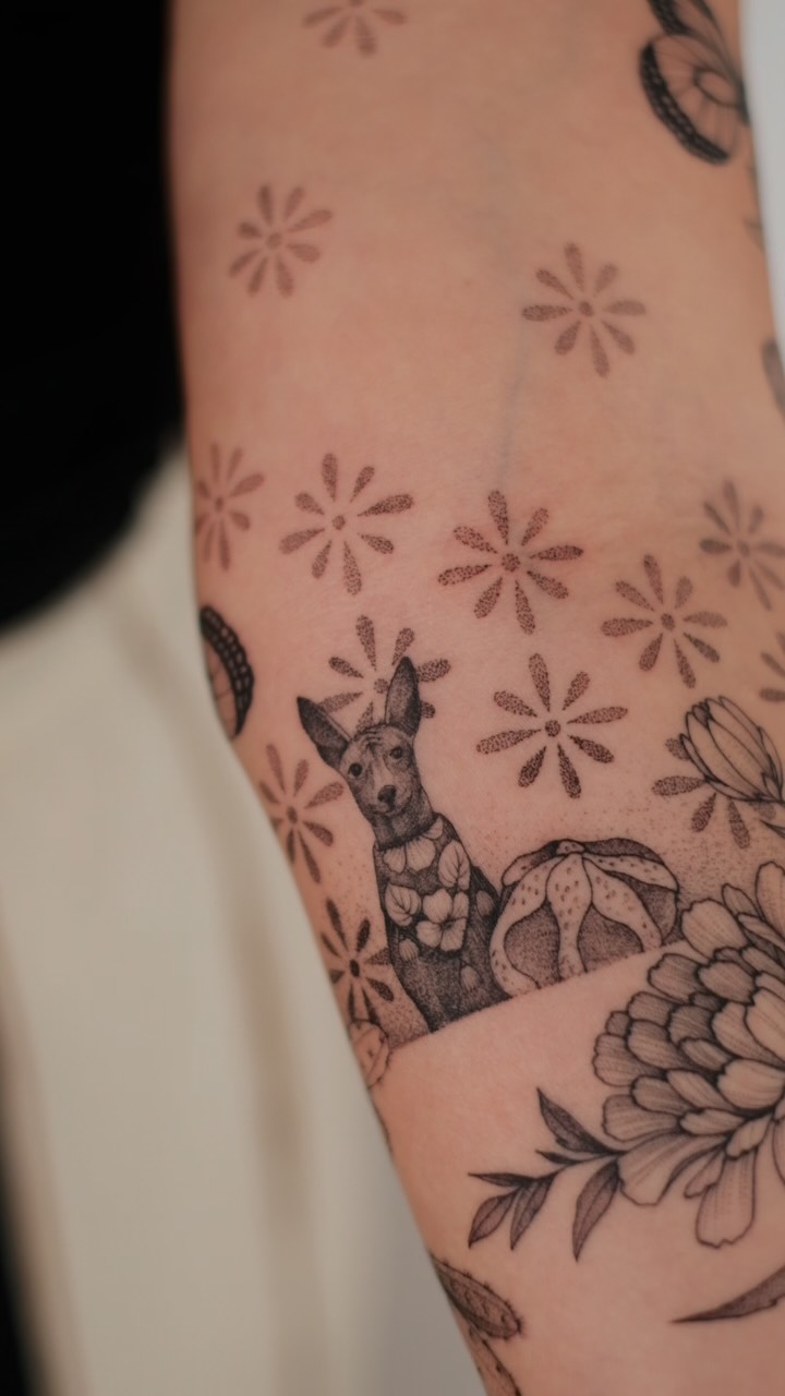 Dotted-dog figure amid delicate floral daisies and blossoms