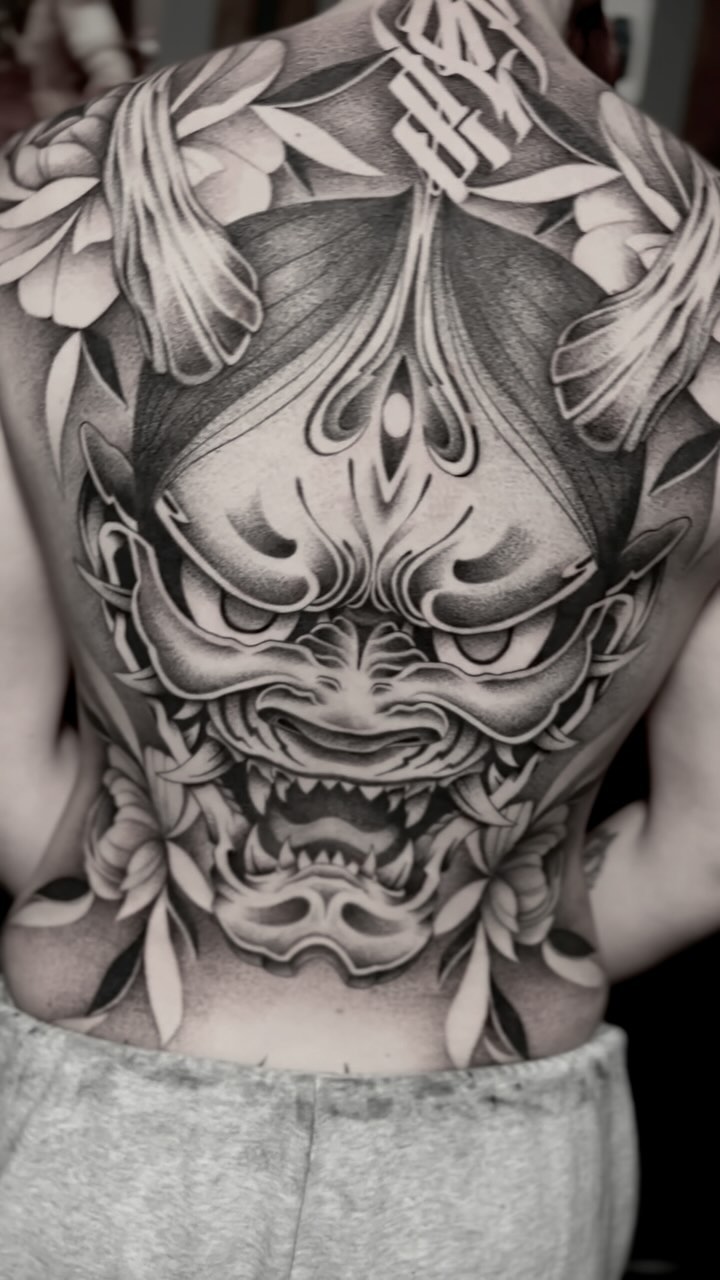 Intense black-and-gray Oni mask with ornate florals