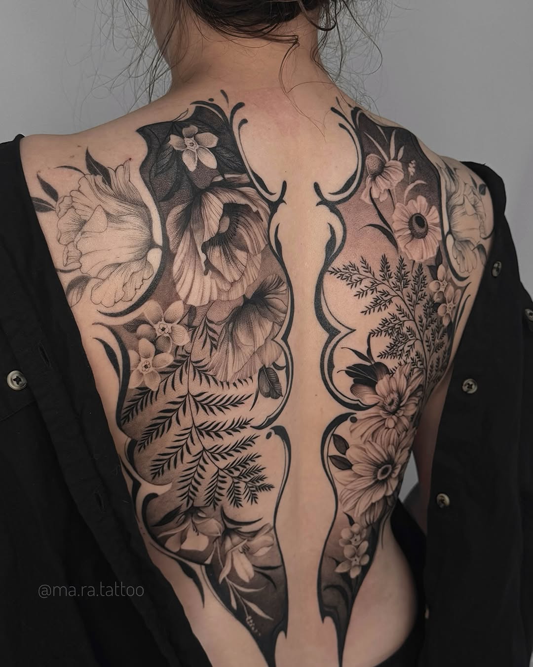 Elegant blackwork floral back piece with bold negative space