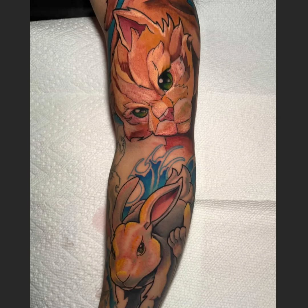 Bold neo-traditional cat-and-rabbit duo on forearm sleeve