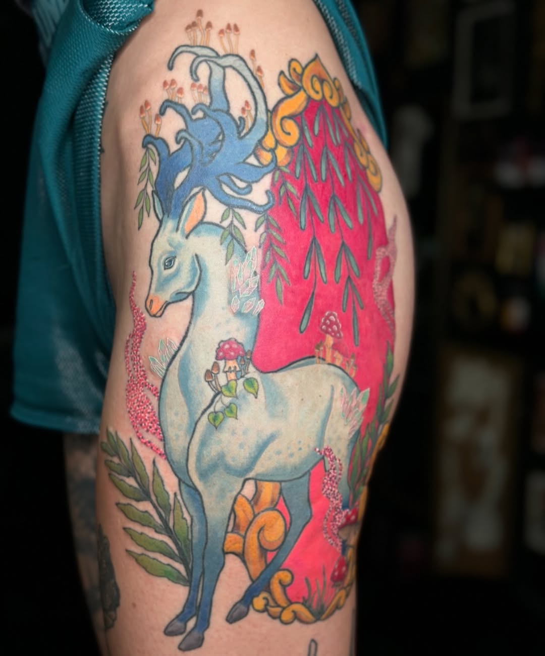 Whimsical blue deer-unicorn with vibrant flora motifs.
