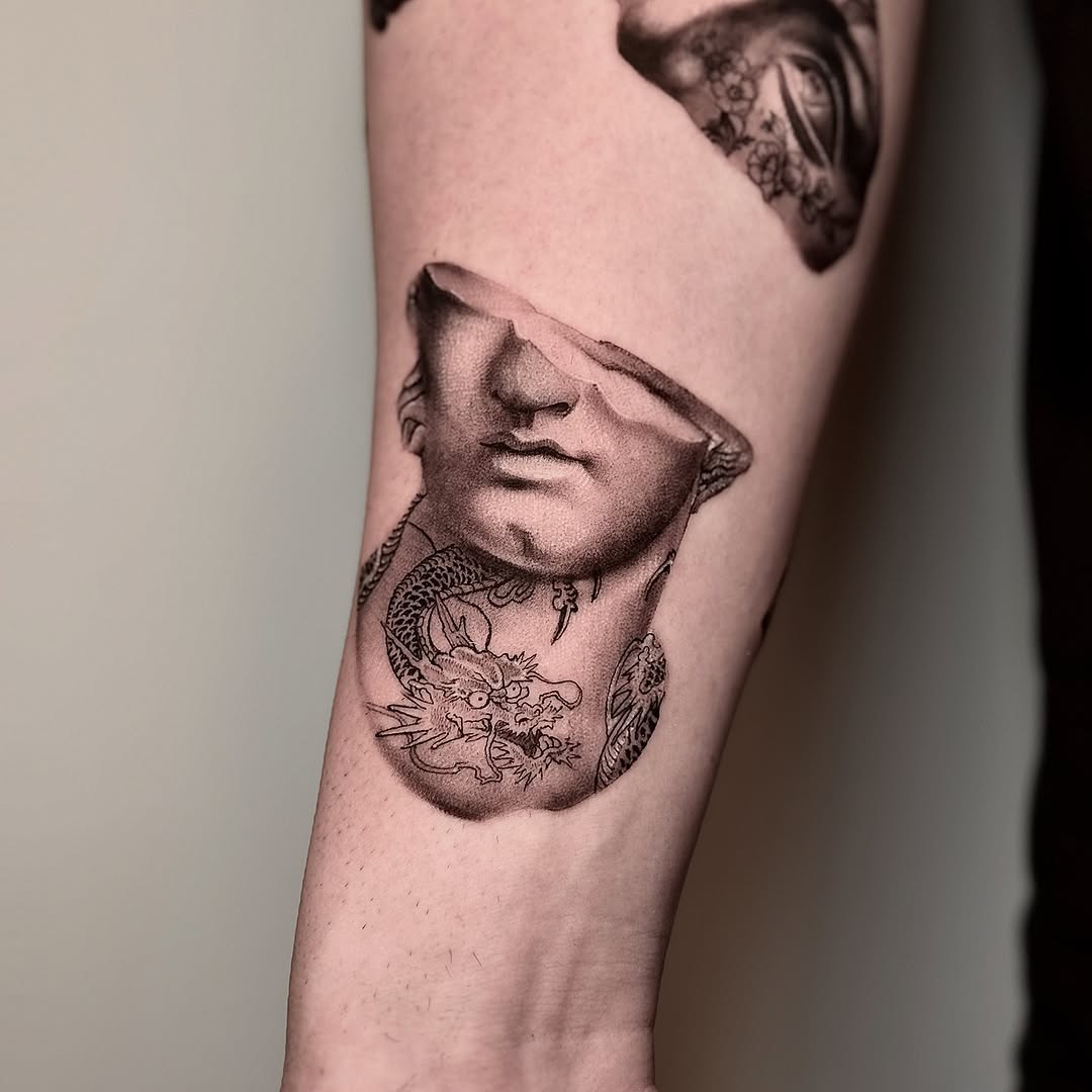 Monumental black-and-gray bust with dragon motifs