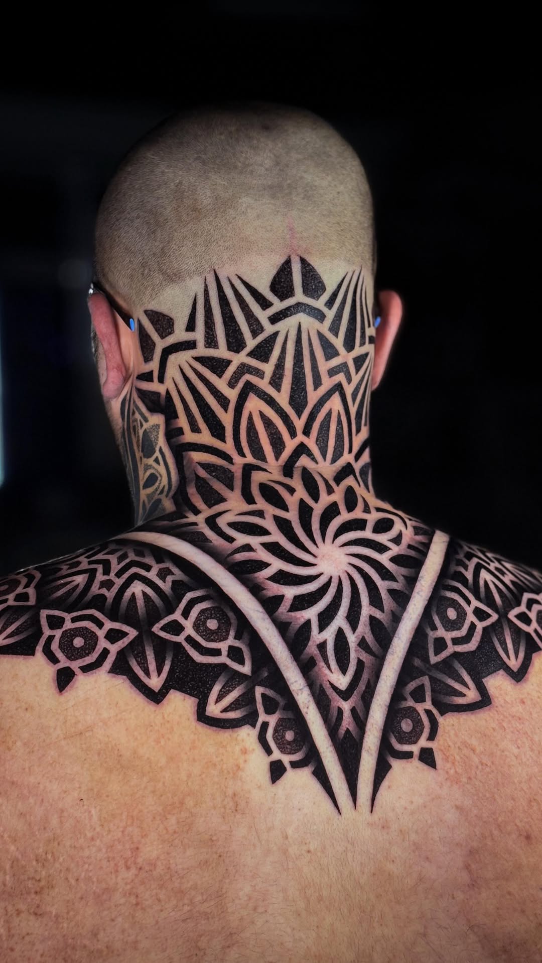 Bold blackwork geometric floral neck-shoulder piece