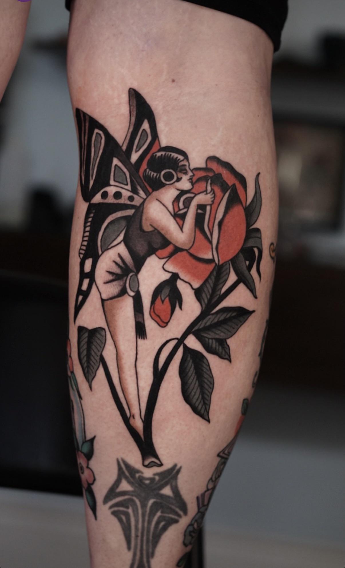 Bold neo-traditional butterfly-woman entwined with crimson roses