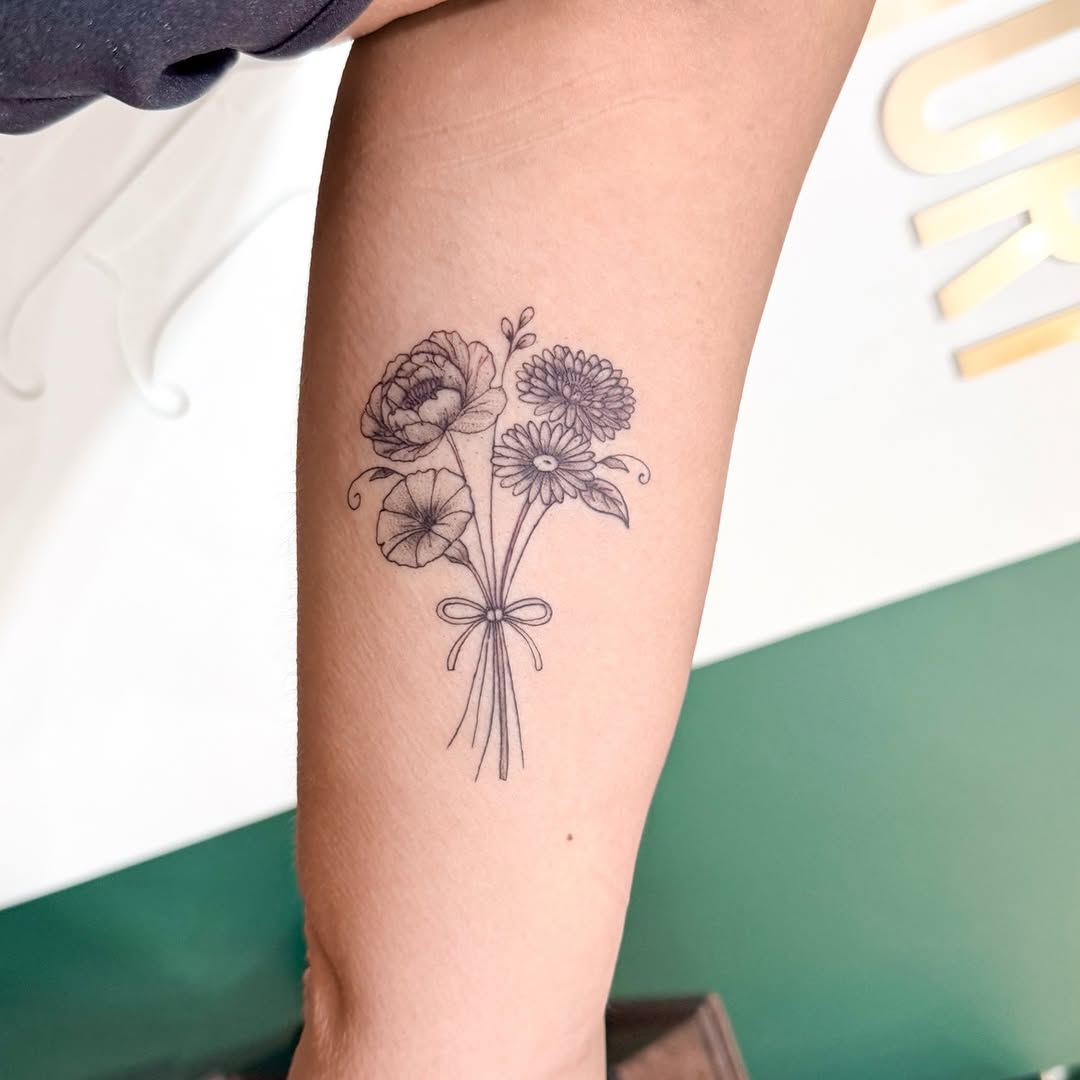 Delicate fine-line bouquet of flowers tied with ribbon