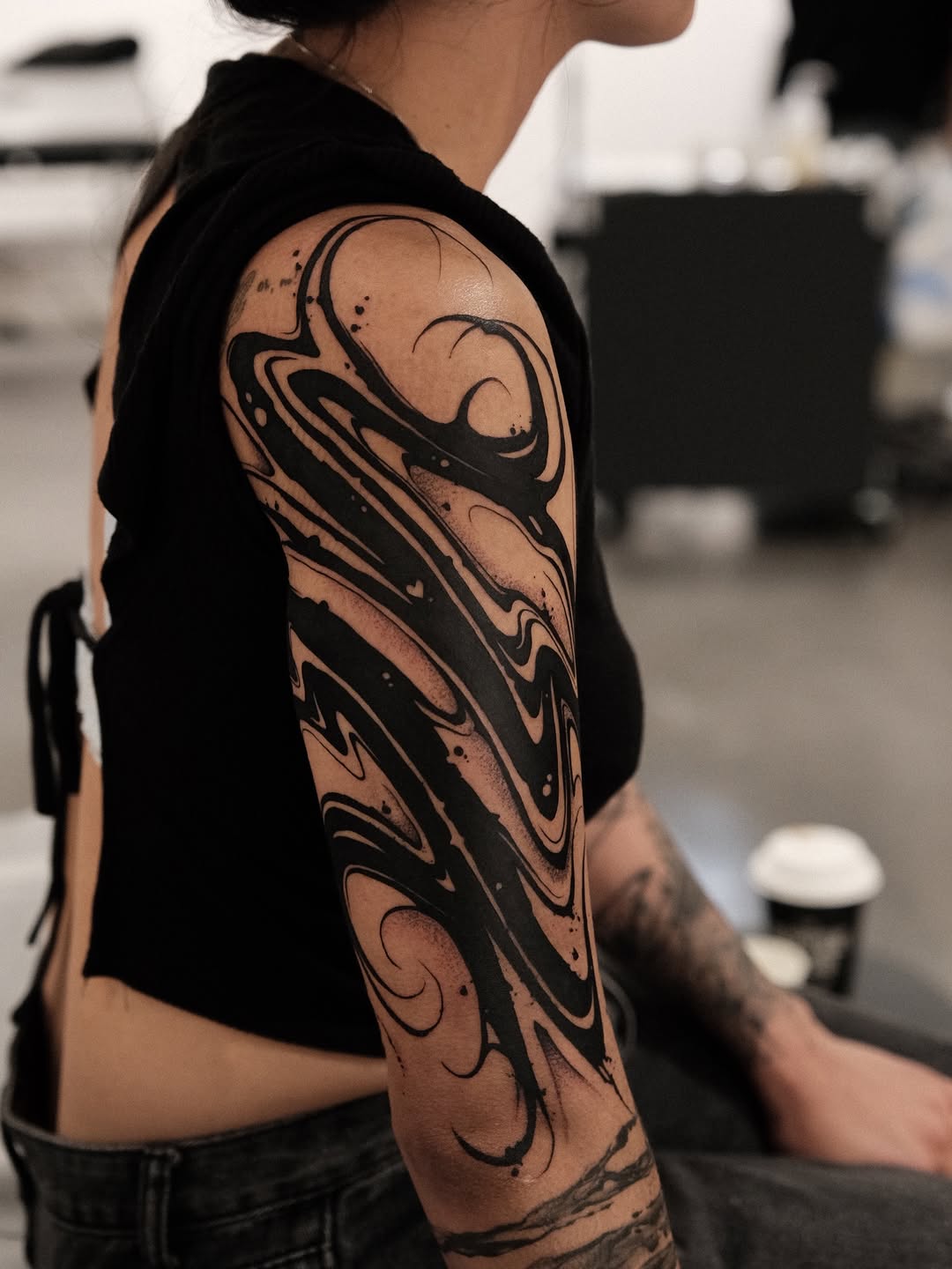 Bold black abstract marbled sleeve with fluid curves