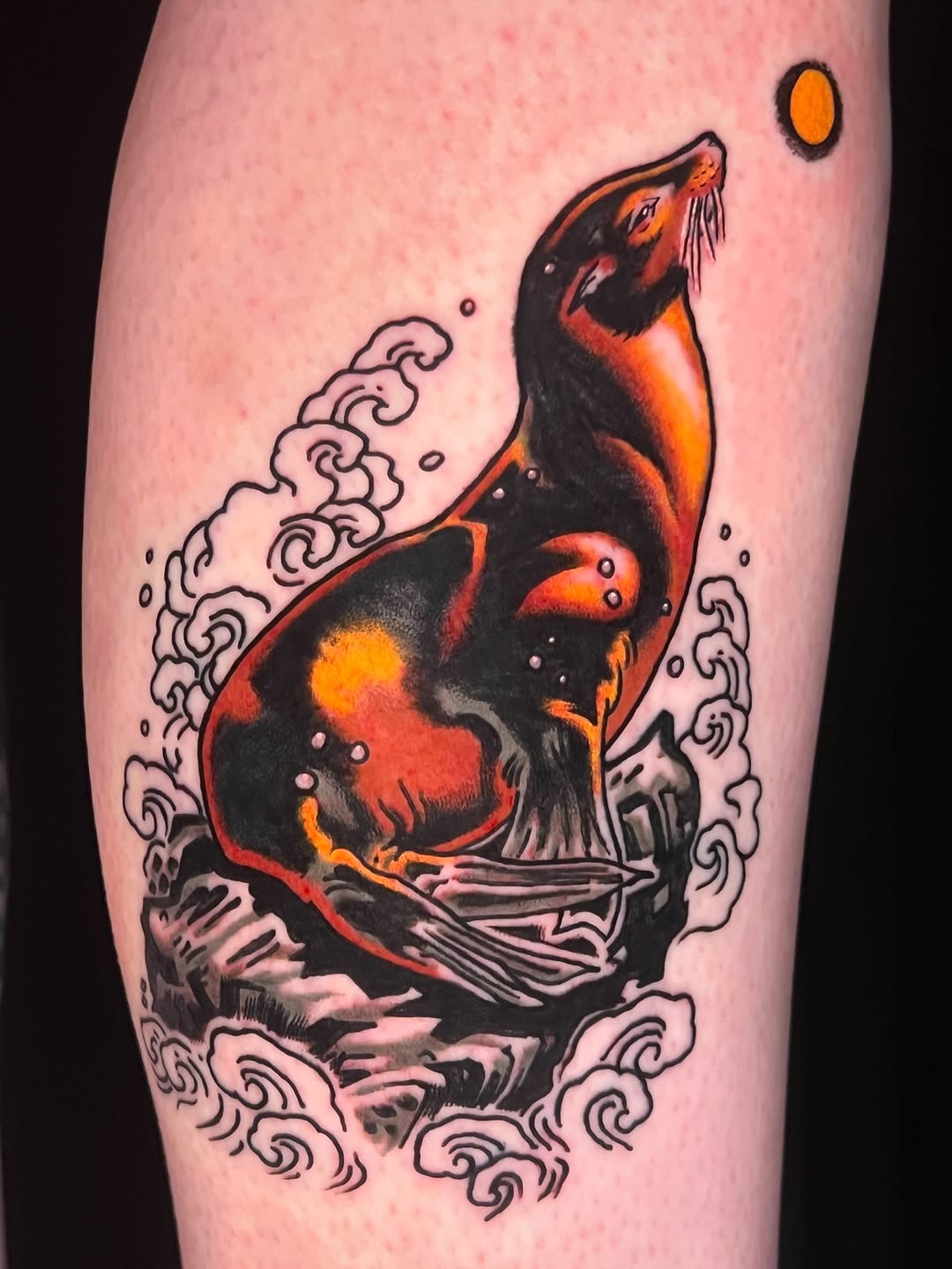 Bold traditional sea lion surrounded by curling waves and sun