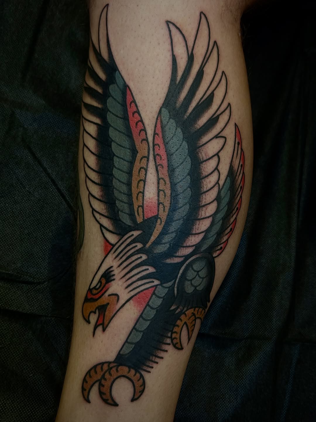 Bold American-traditional eagle with vivid colors and sweeping wings.