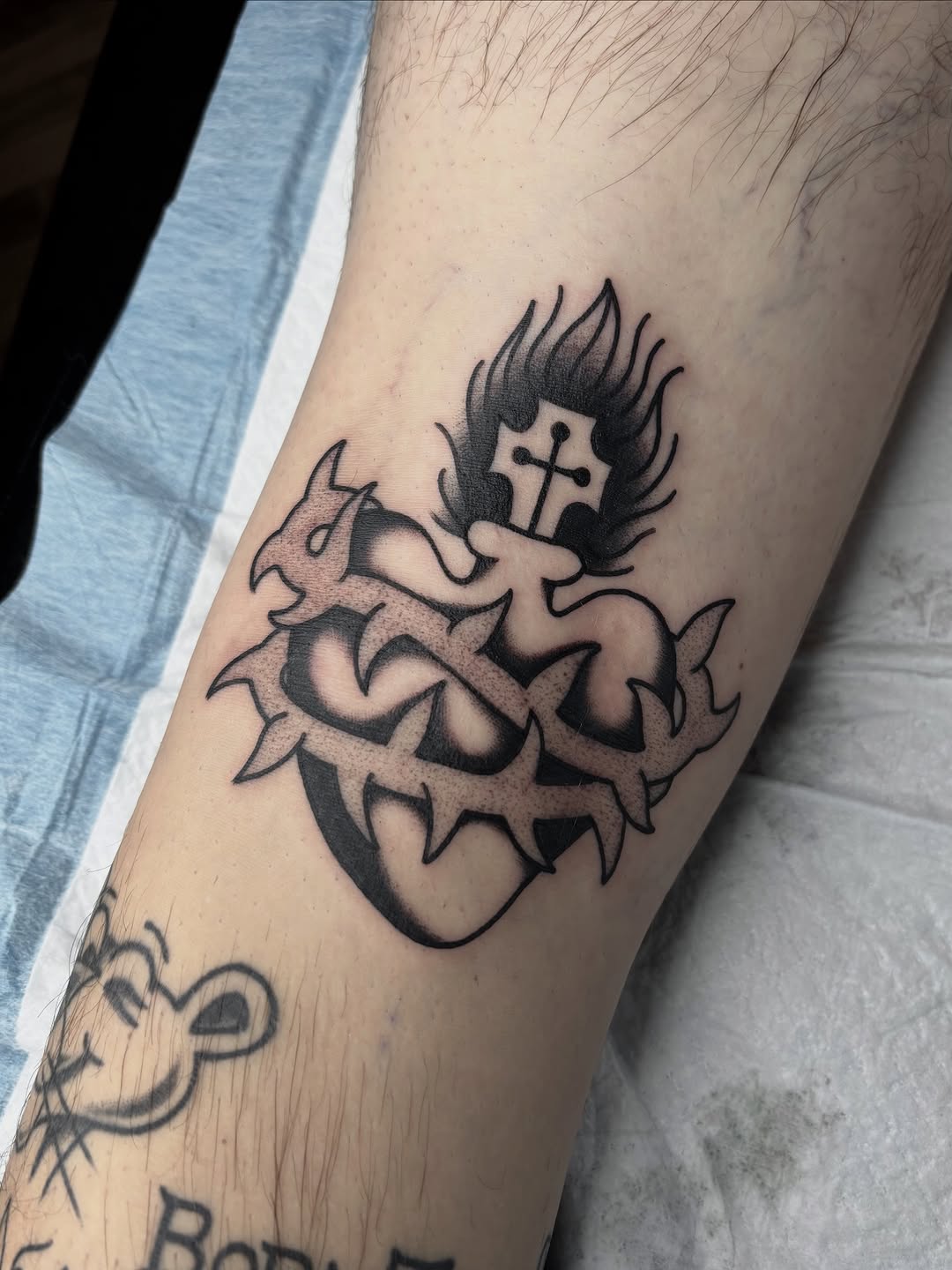 Bold blackwork sacred heart with thorny crown and flames
