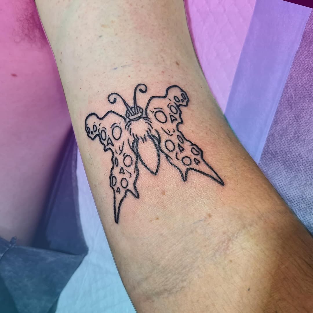 Symmetrical butterfly wings, bold outlines with cut-out dot pattern