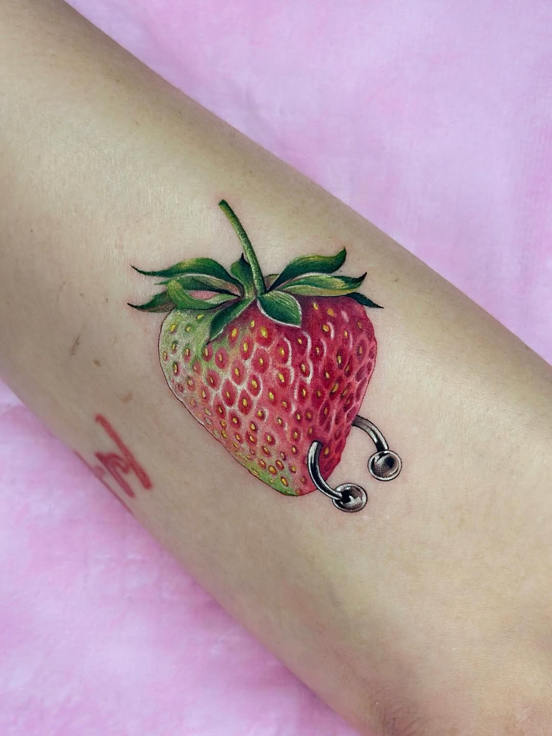 Bright strawberry with gleaming metallic ring accent