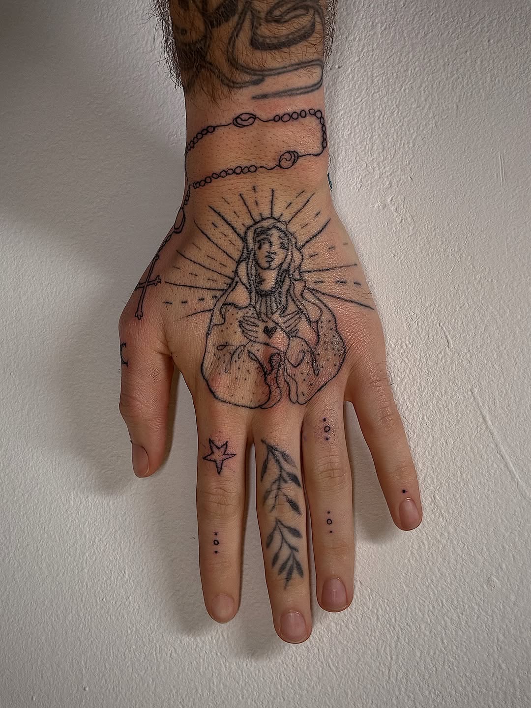 Hand tattoo of Mother figure