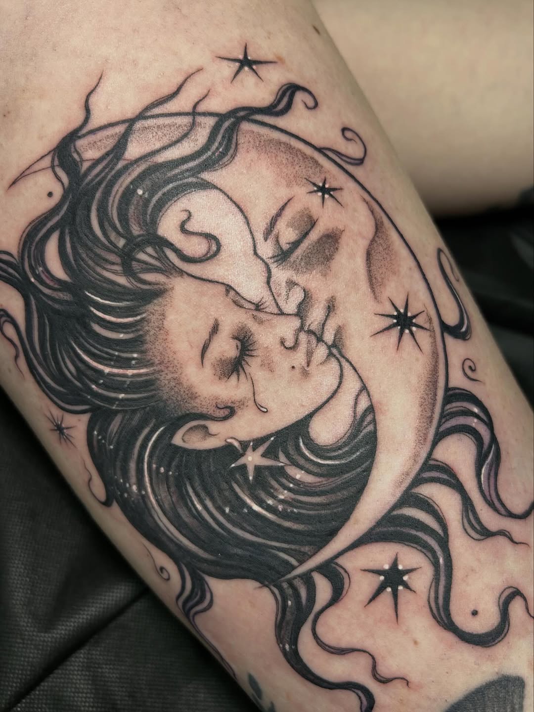 Celestial moon embraces sleeping woman, flowing hair.