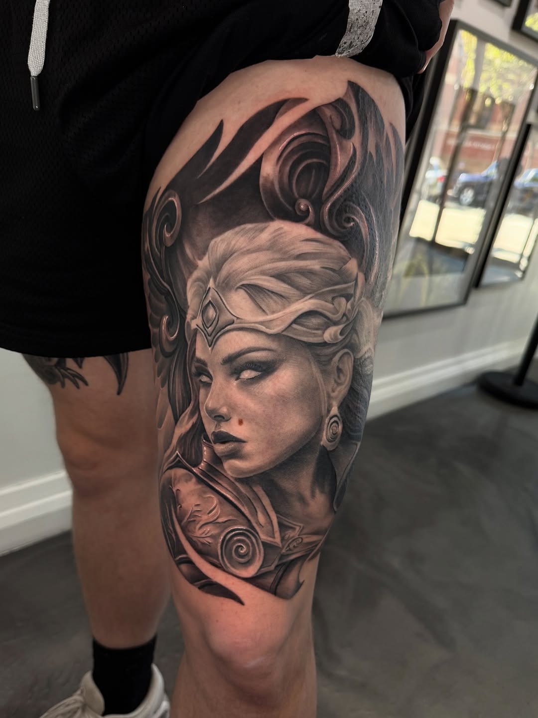 Monochrome angel portrait with ornate headpiece and swirls