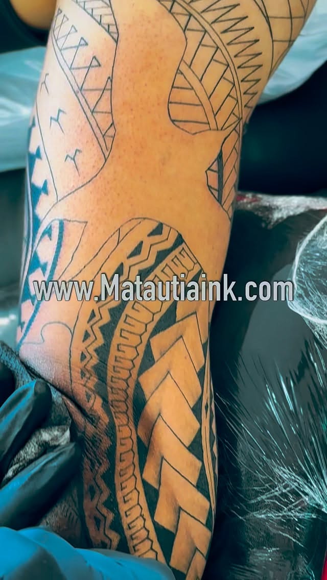 Bold Polynesian tribal sleeve with interwoven chevron patterns.