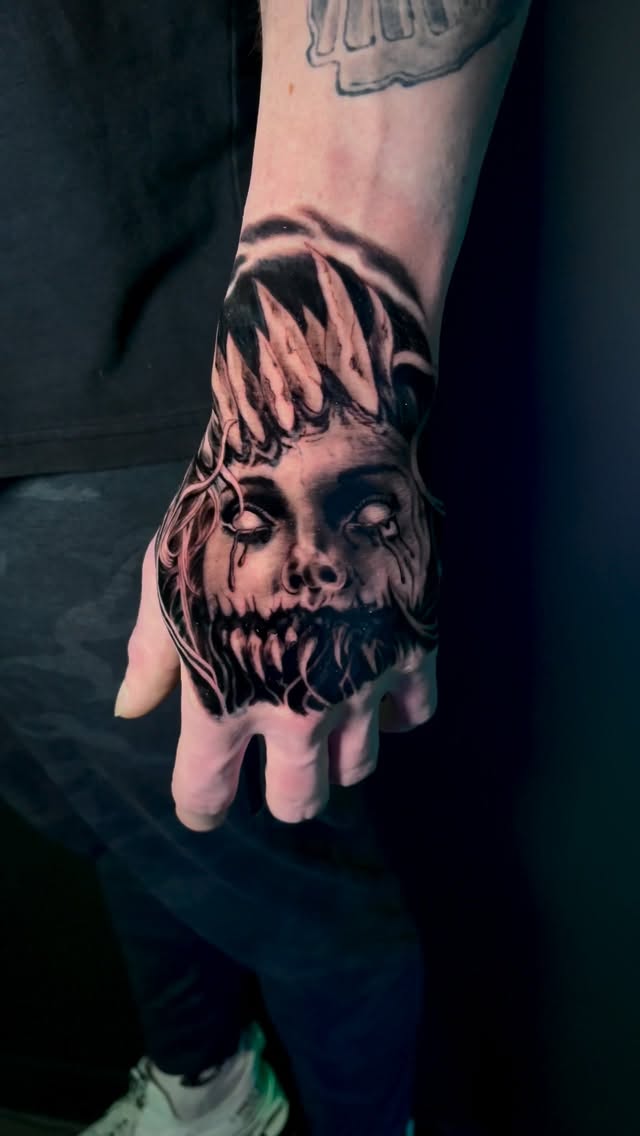 Chilling blackwork horror skull on the back of the hand