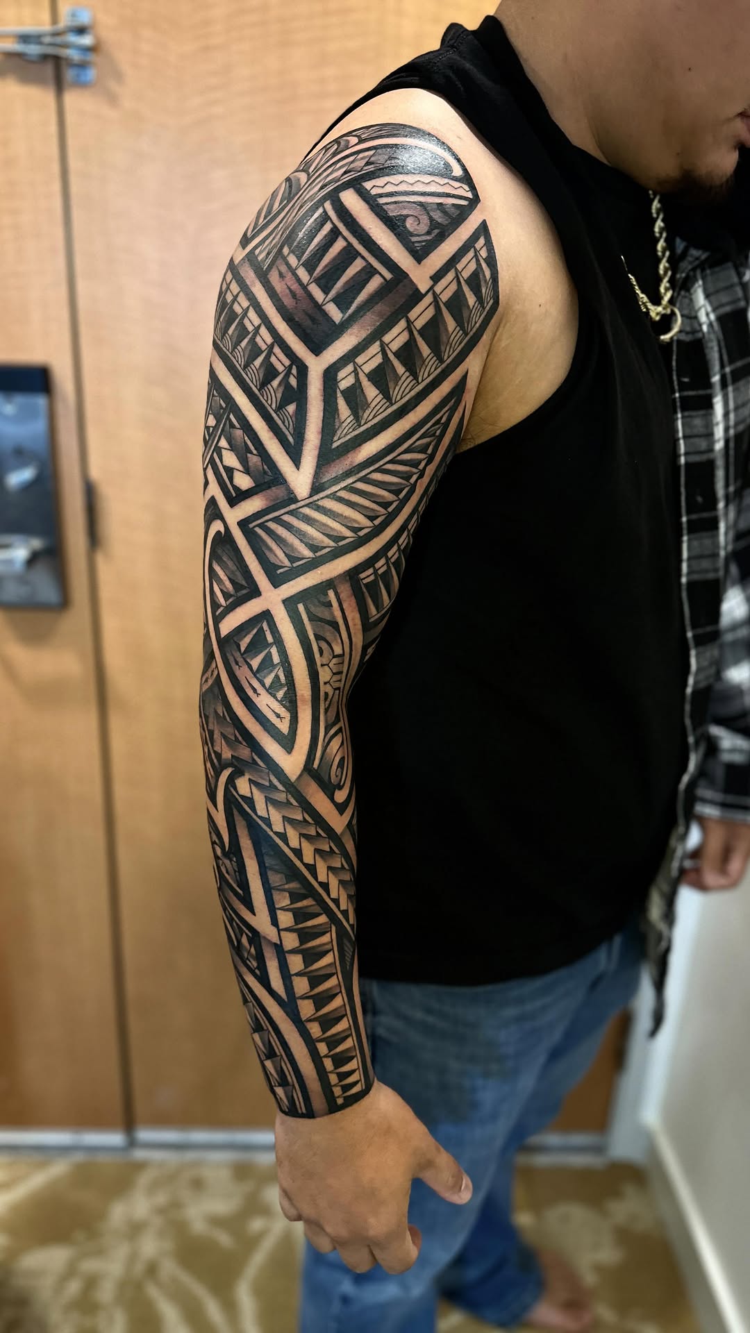 Bold Polynesian blackwork sleeve with geometric motifs