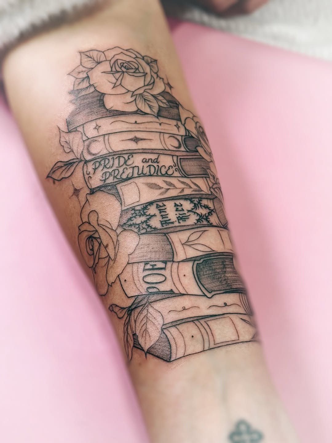 Stack of classic novels with roses and banner