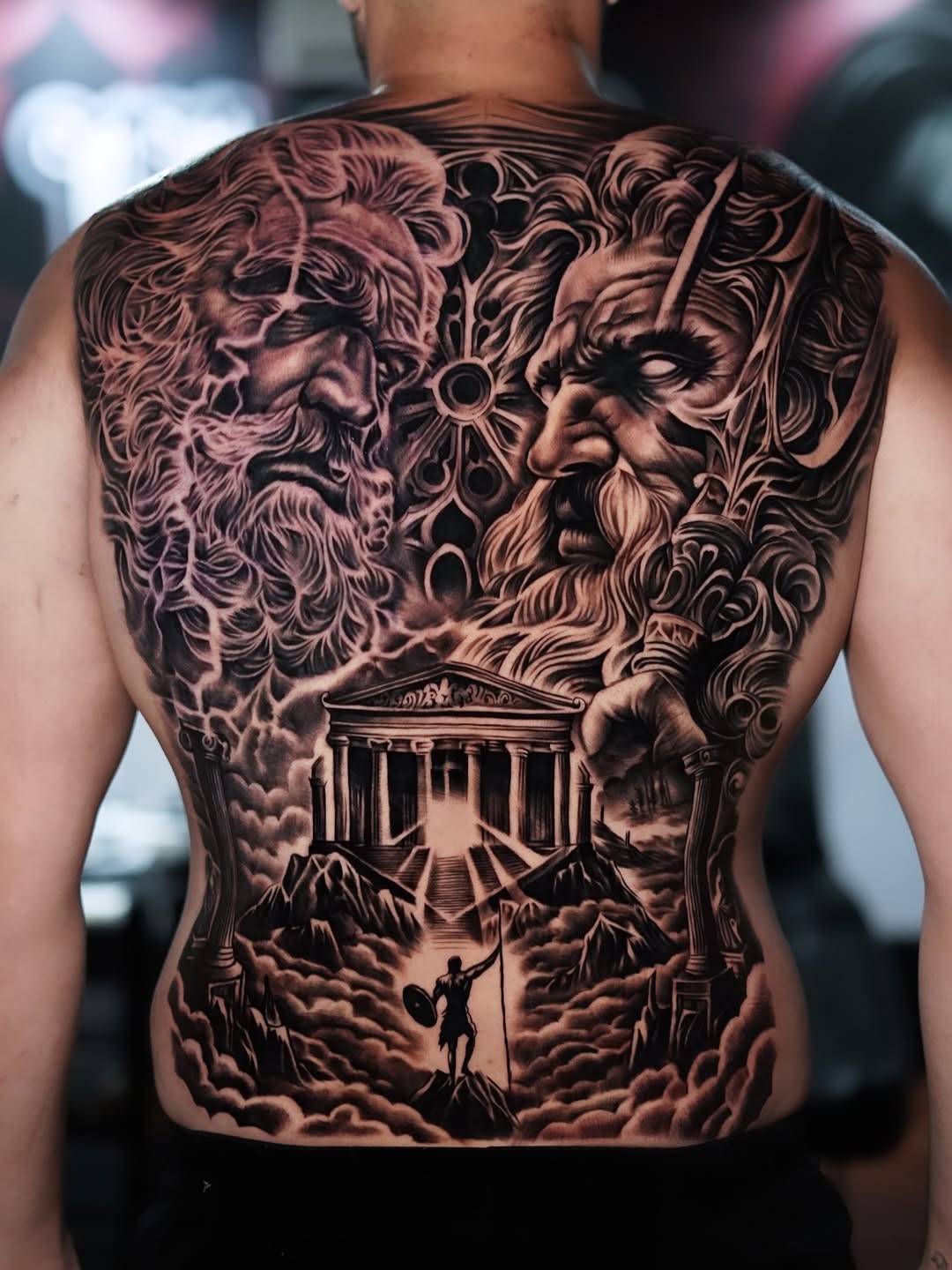 Dramatic black-and-gray mythic duel over ancient temple.