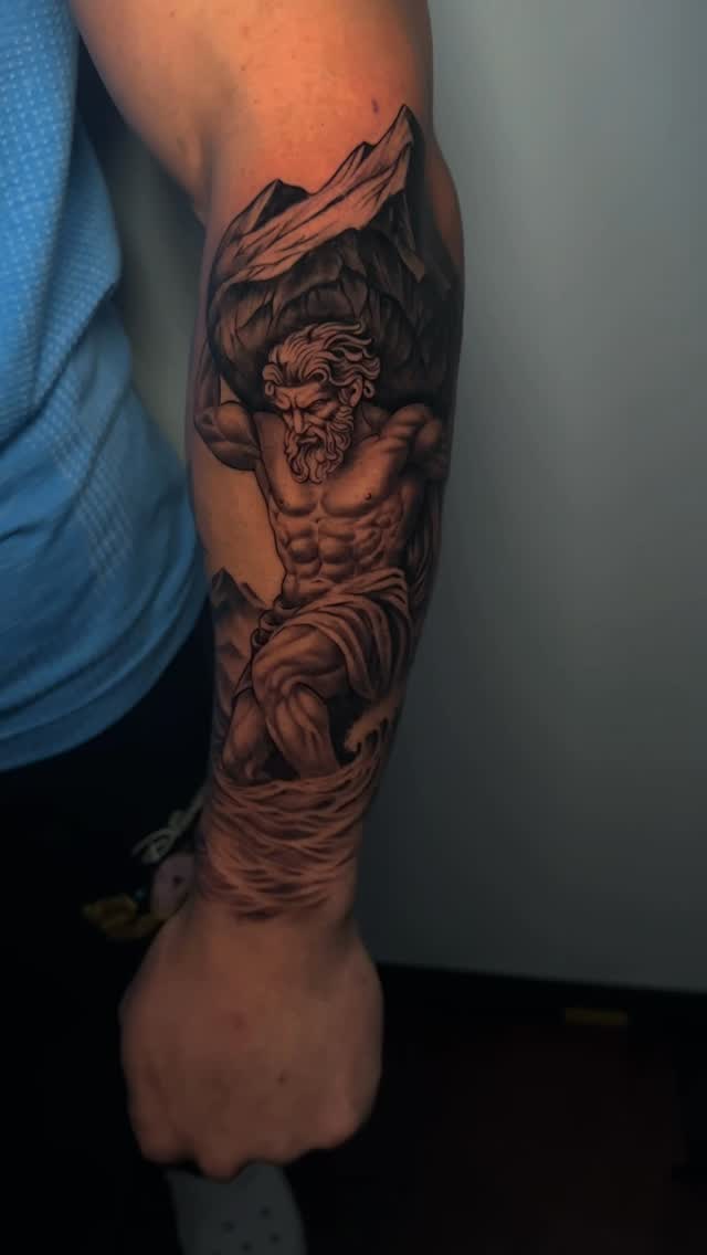 Classical Atlas figure in grayscale with towering mountains.