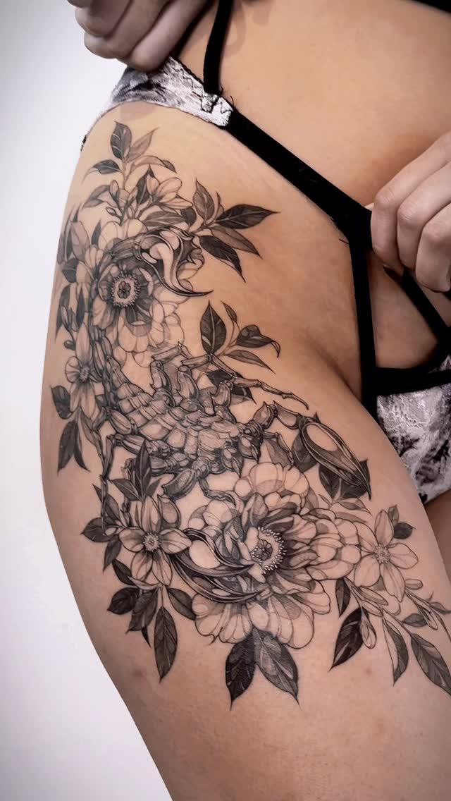Intricate black-and-gray floral sleeve with a scorpion centerpiece