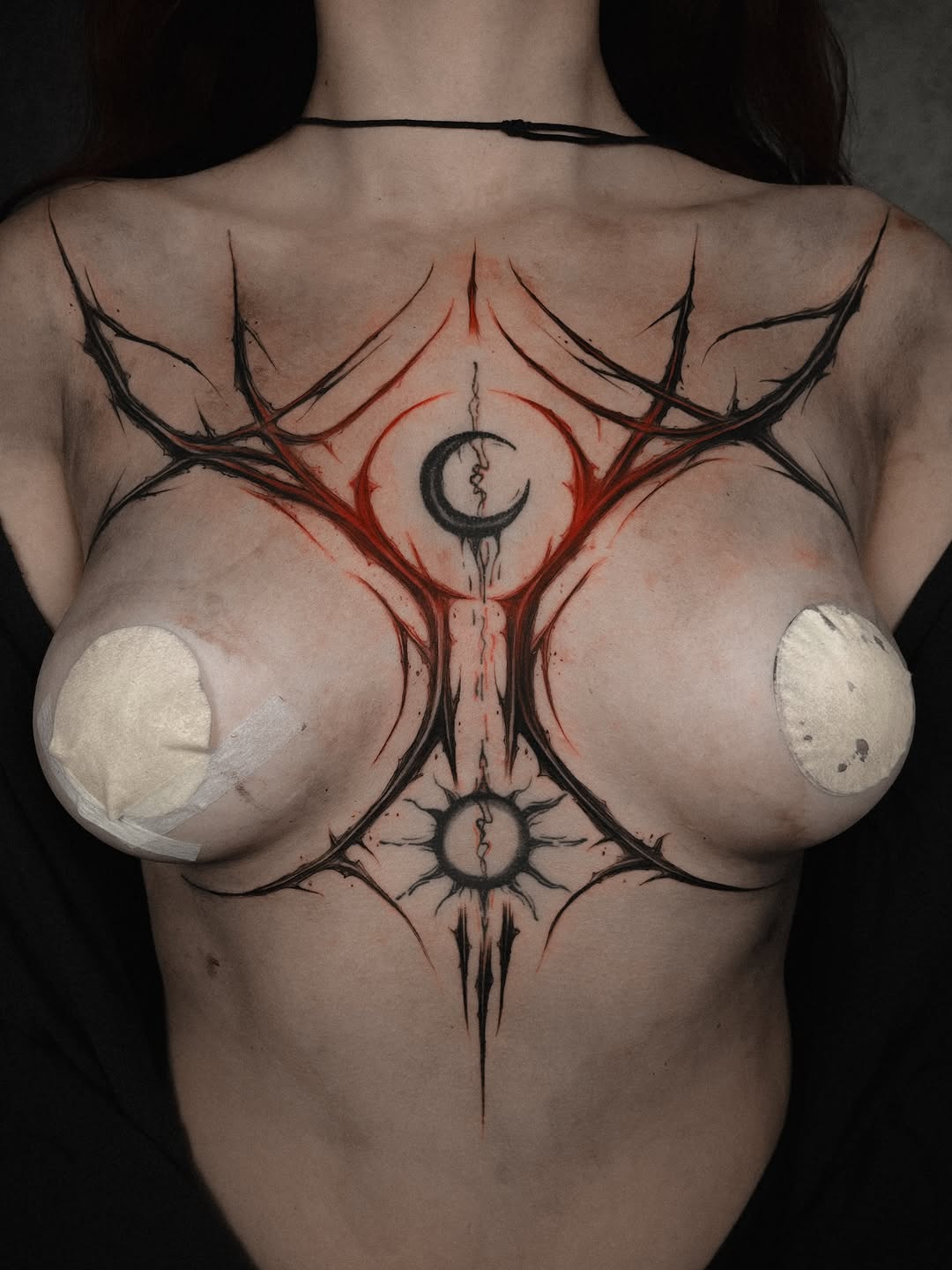 Bold blackwork back piece featuring crescent moon and organic symmetry