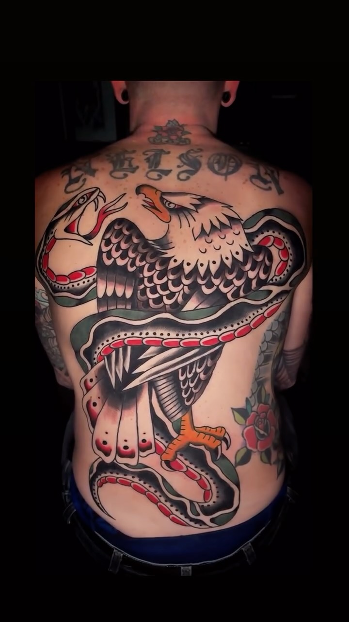 Bold American-traditional back piece with eagle and snake