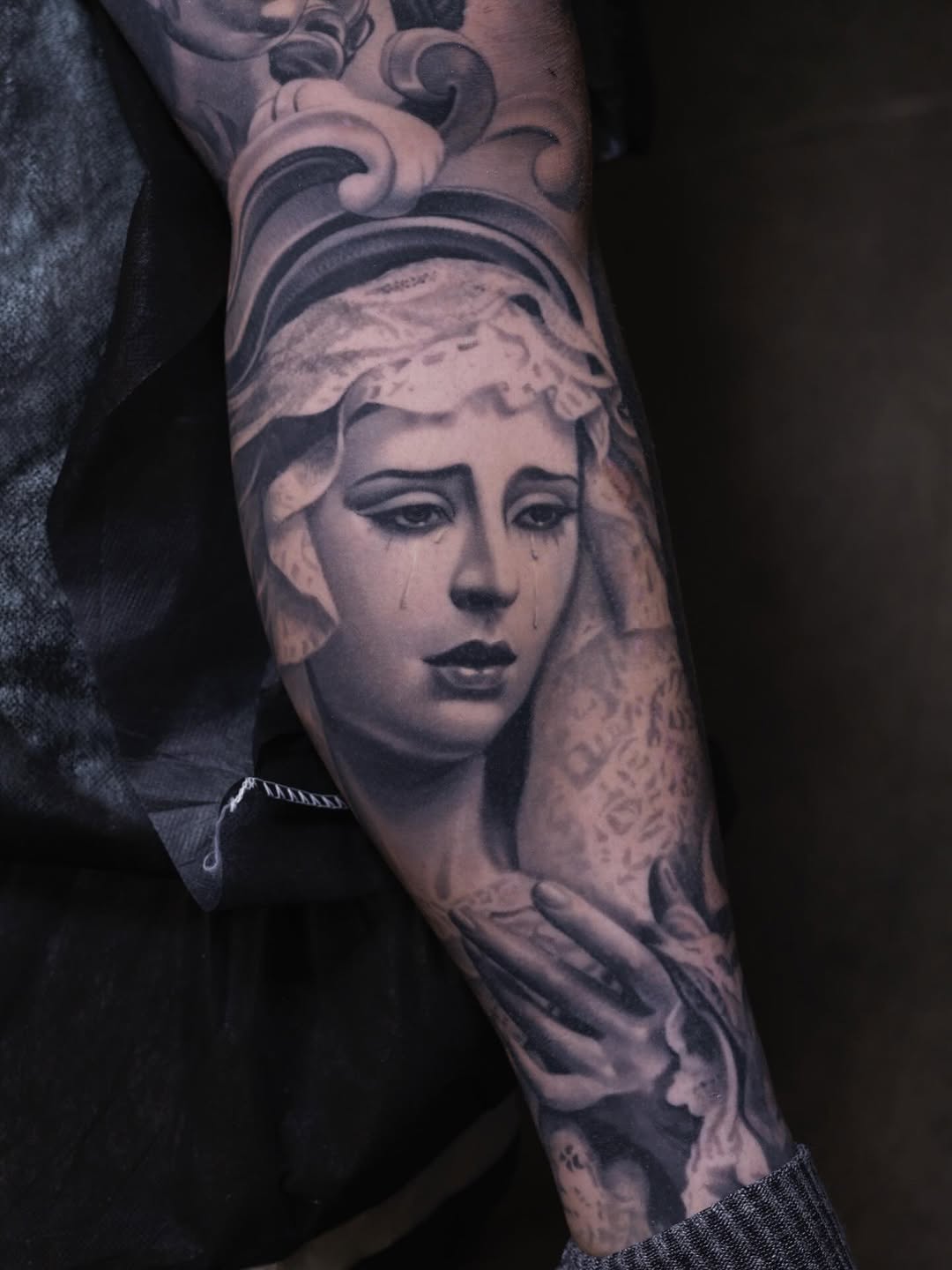 Grayscale realism of tearful classical maiden on forearm