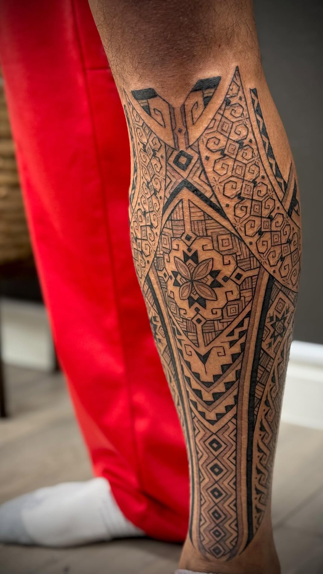 Intricate geometric Polynesian-inspired leg sleeve in blackwork