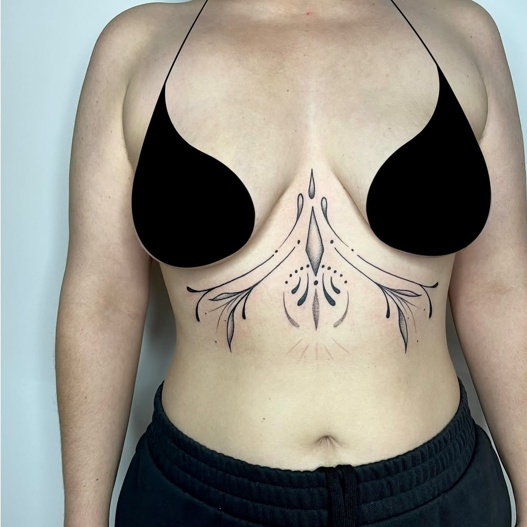 Symmetrical sternum-centered ornamental filigree with floral accents