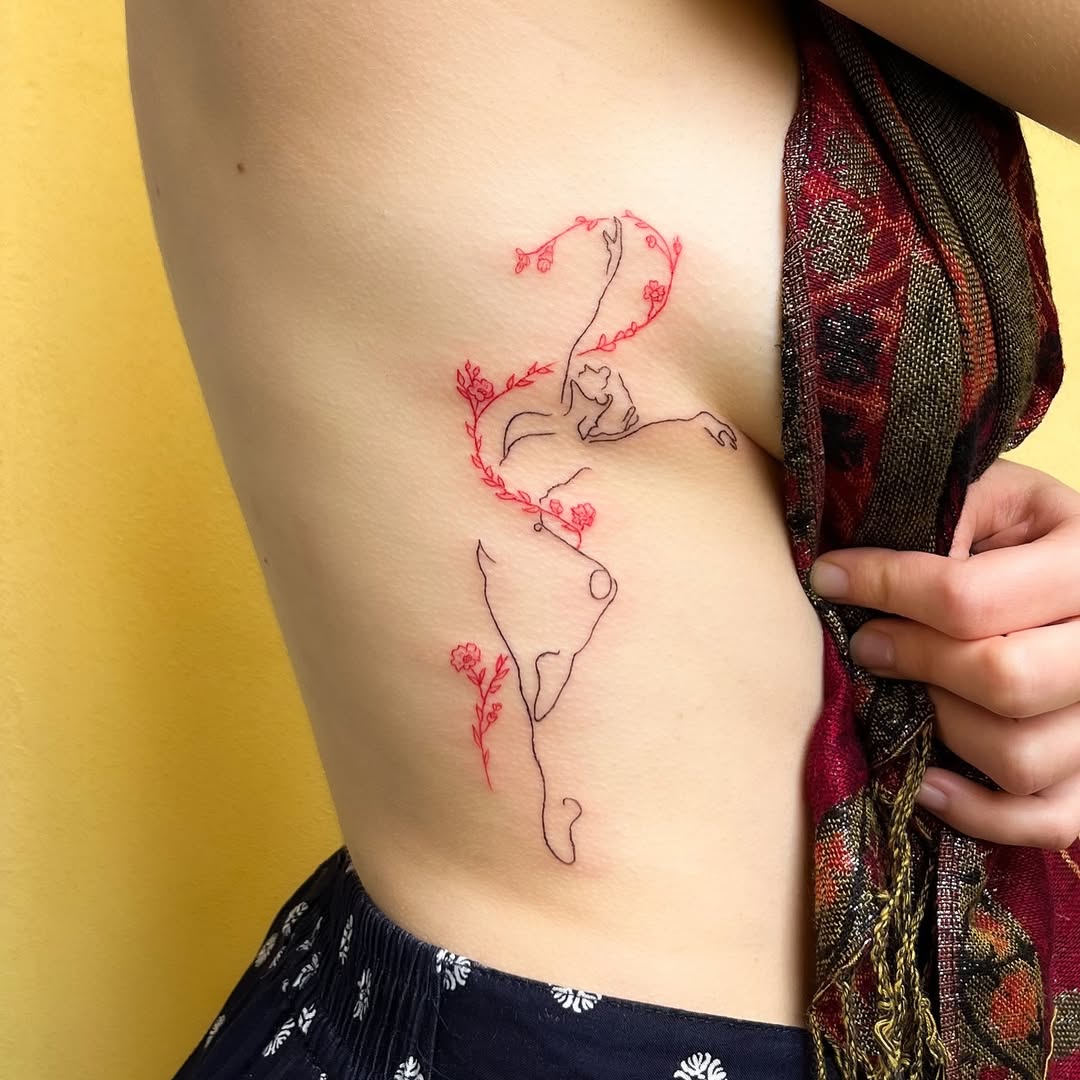 Delicate fine-line dancer silhouette entwined with red florals