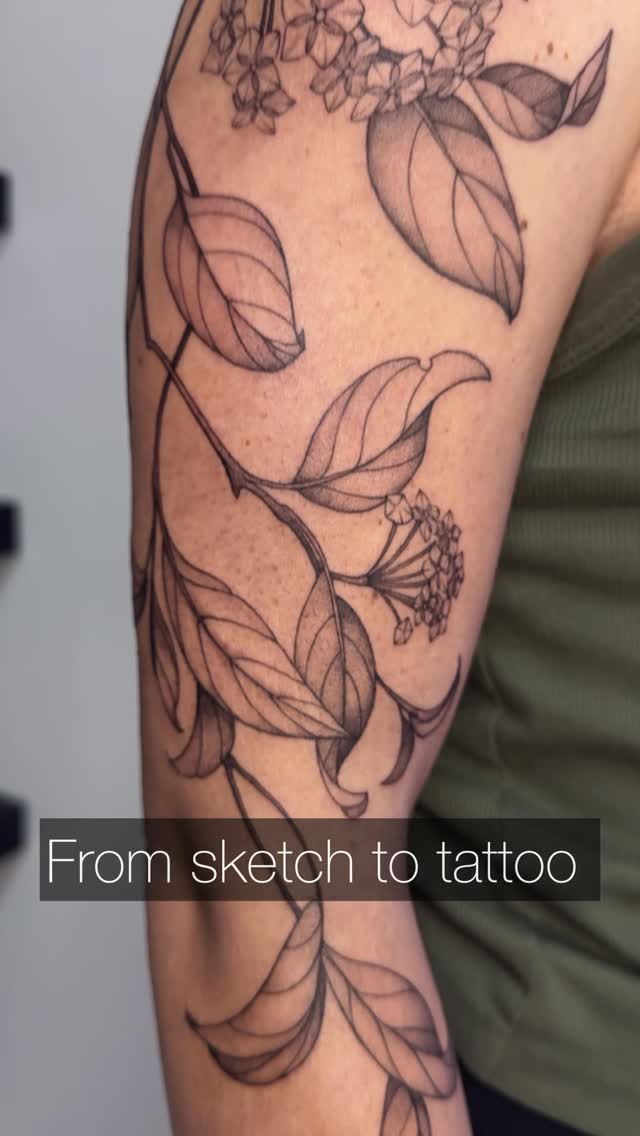 Delicate botanical linework on forearm with leaves