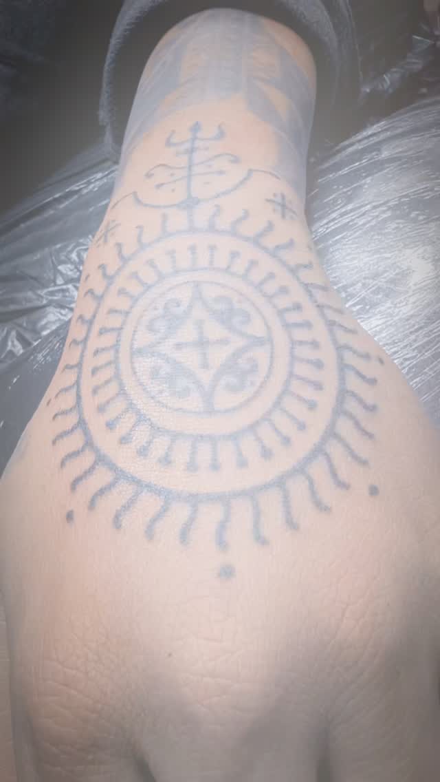 Sacred circular mandala with dotwork outer rays