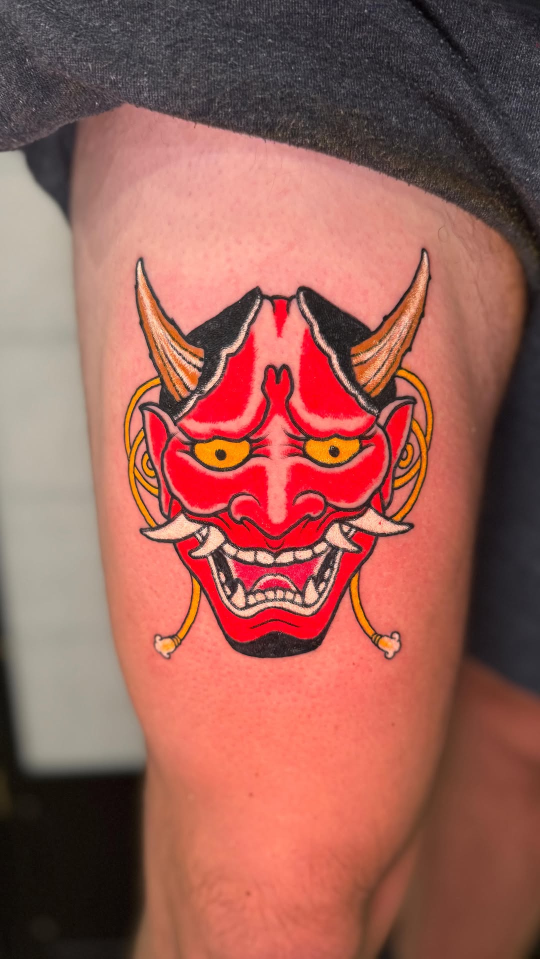 Bold red Hannya mask with fierce yellow eyes