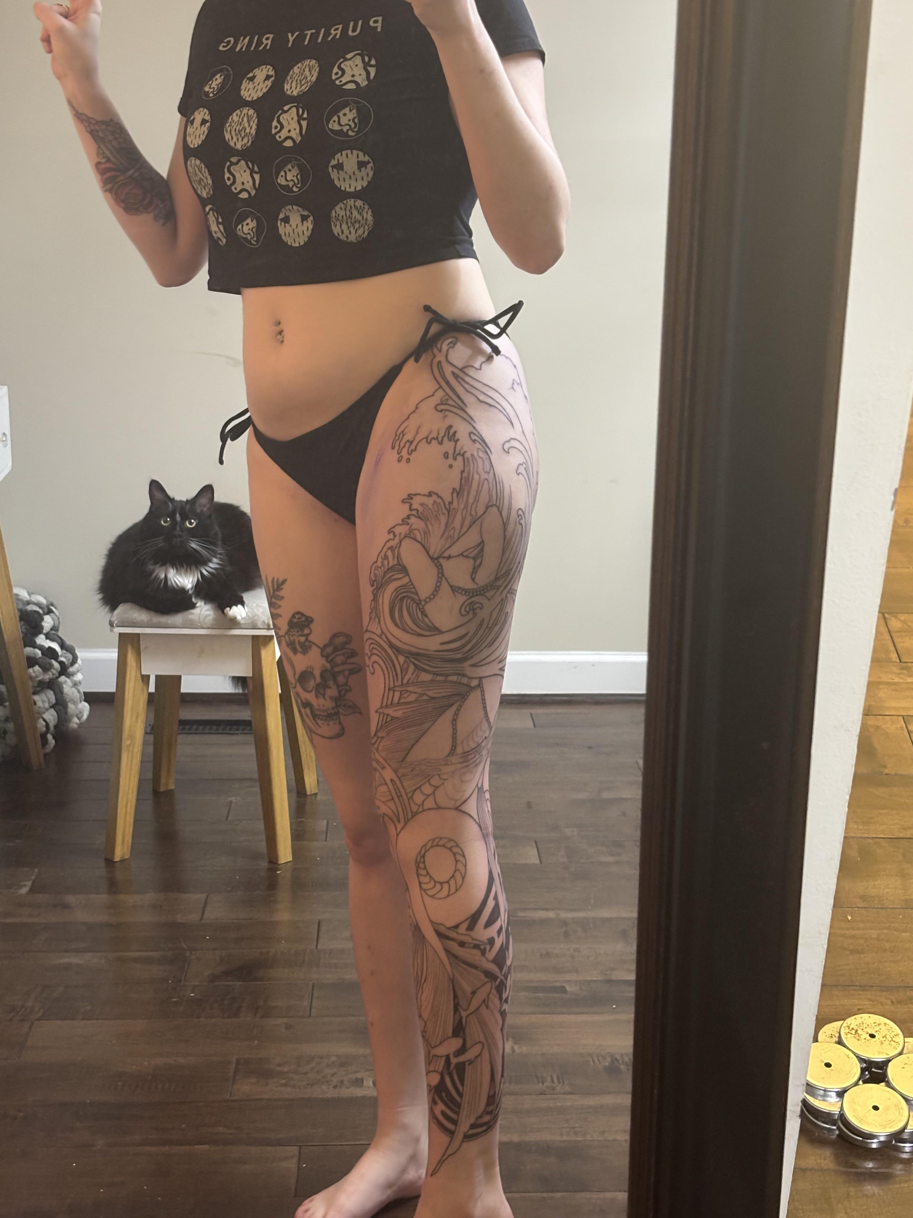 Intricate mermaid leg sleeve with flowing waves and nautical motifs