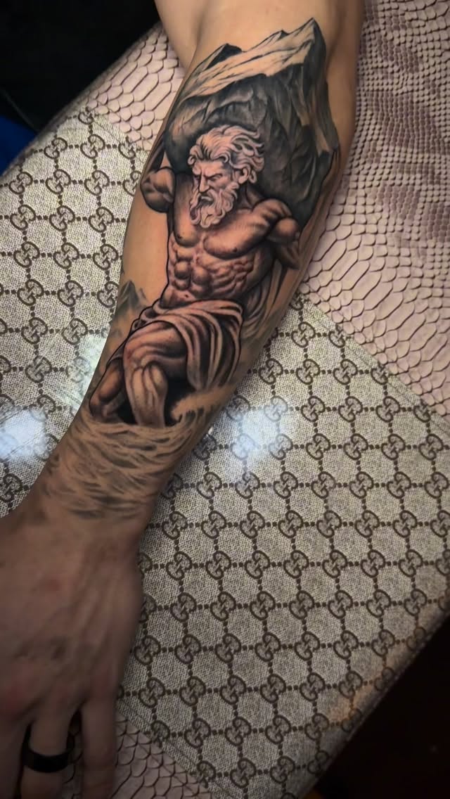 Monumental black-and-gray mythic warrior on forearm