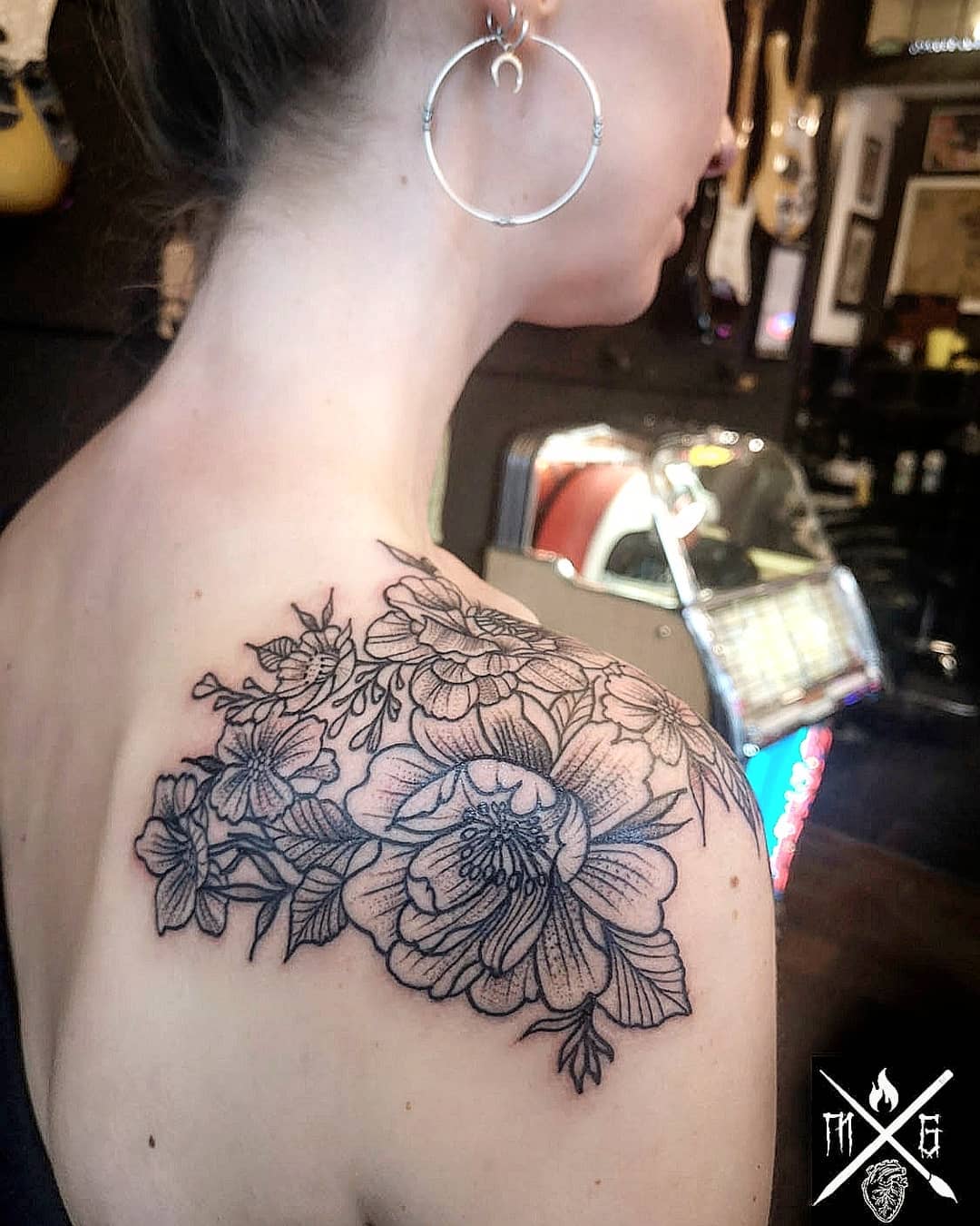 Intricate blackline floral shoulder piece with layered blossoms