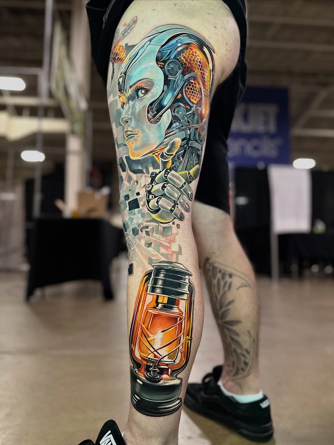 Vibrant biomechanical leg sleeve with neon, cybernetic detail