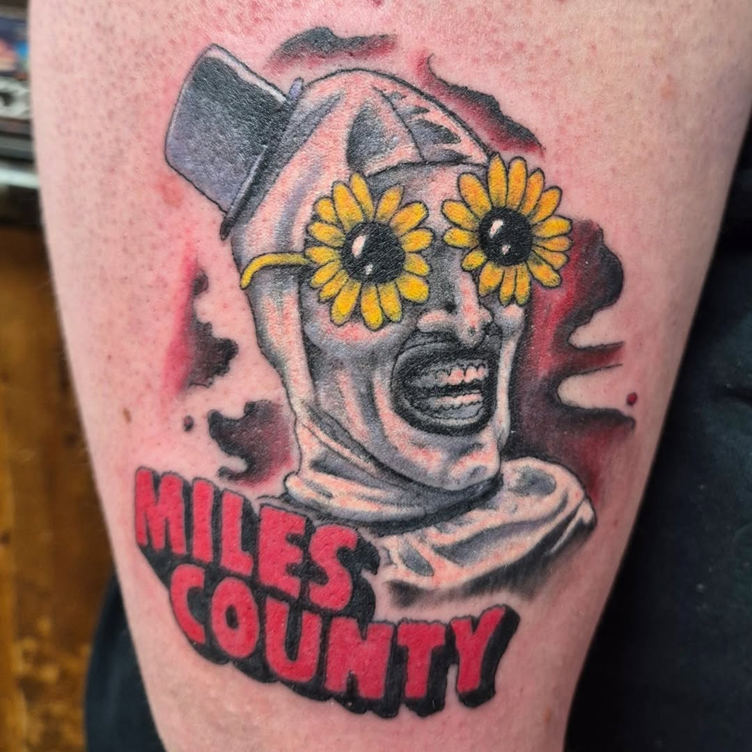 Bold neo-traditional clown with sunflower eyes and Miles County text