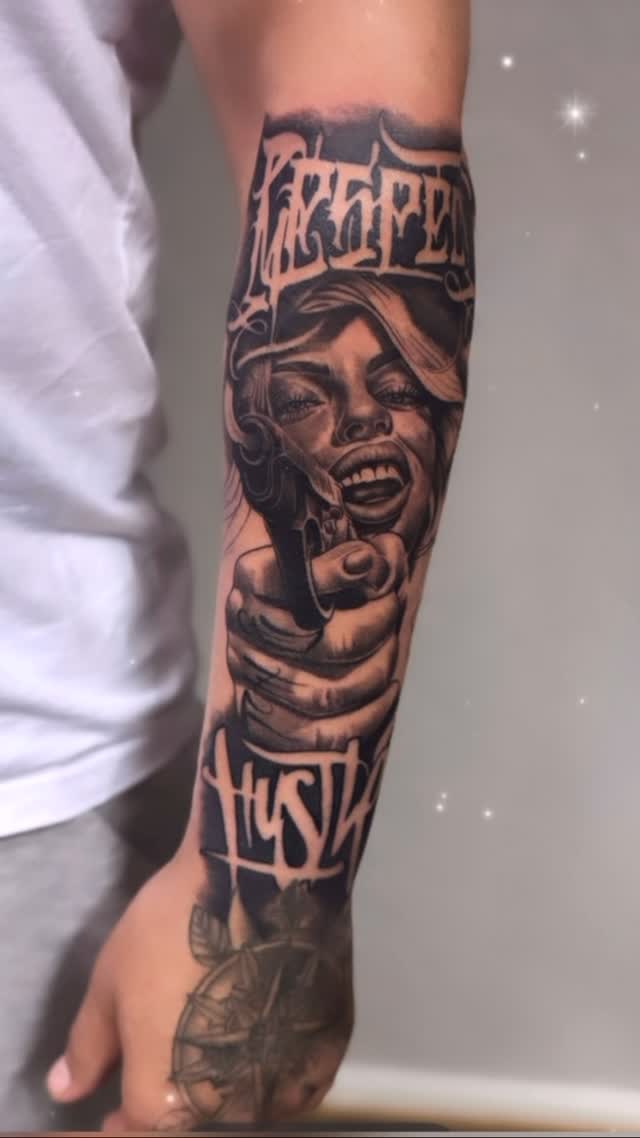 Bold black-and-gray forearm piece featuring fierce female portrait