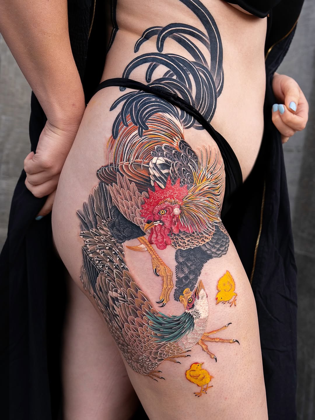 Vibrant neo-traditional rooster family thigh piece with chicks