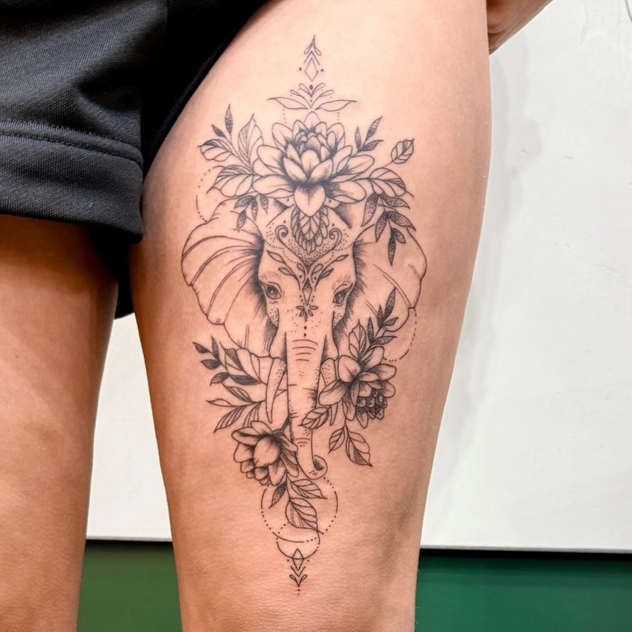 Intricate elephant-head tattoo with lotus crown and floral mandala