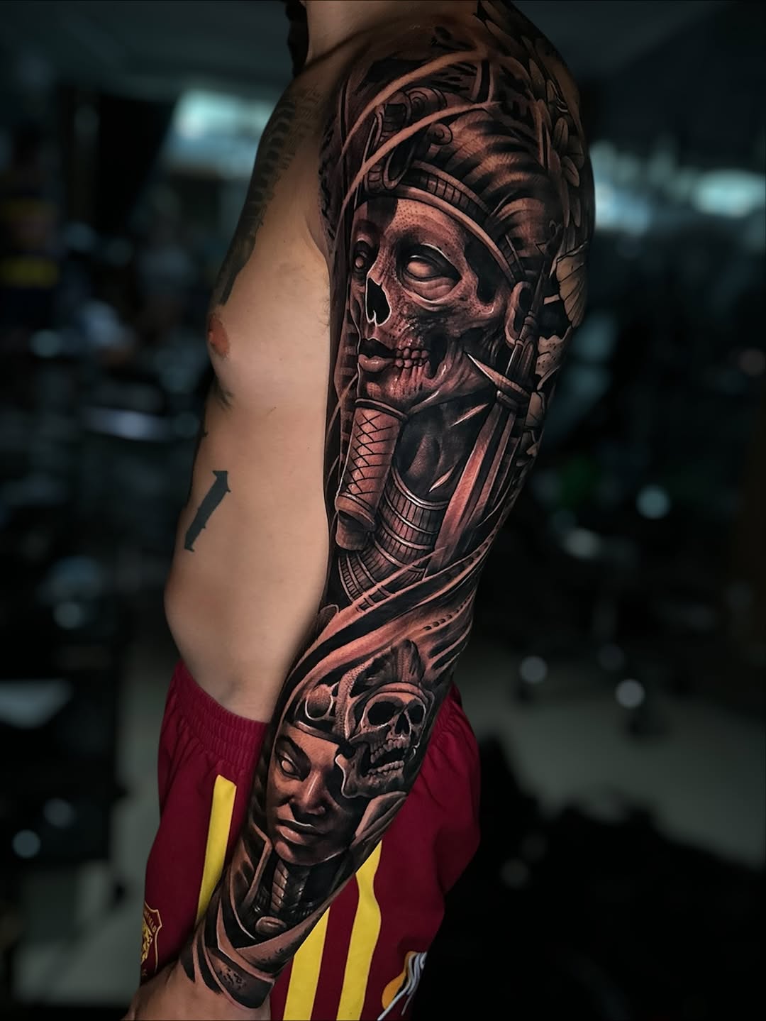 Hyper-detailed black-and-gray biomechanical skull sleeve with gears