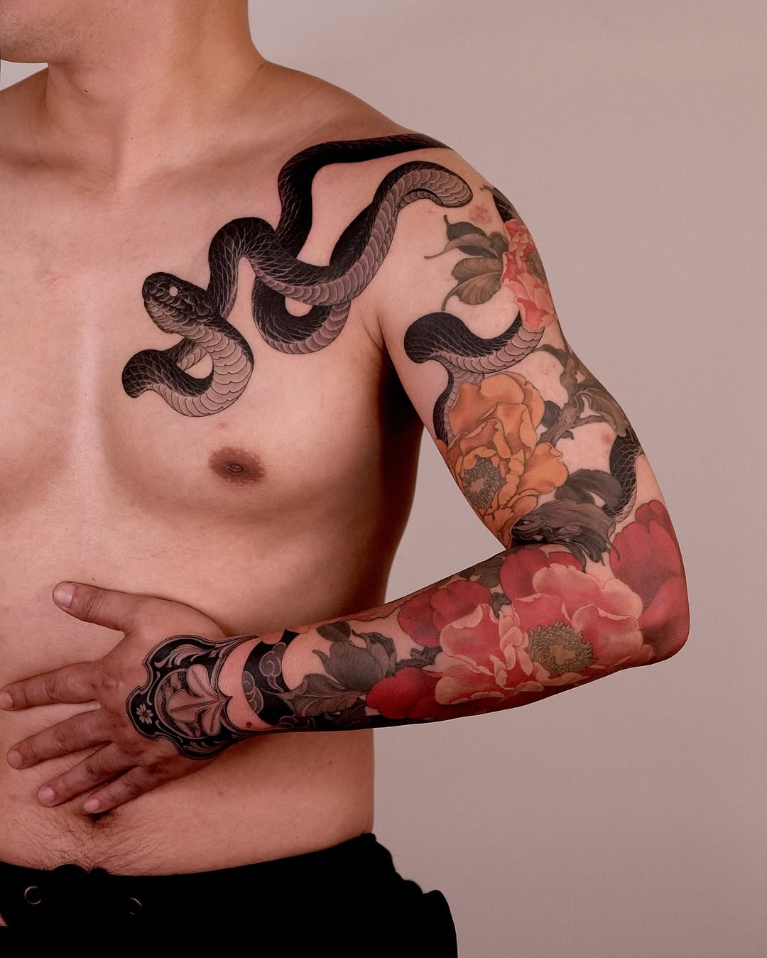 Coiled black snake over vibrant peony blossoms, Japanese-inspired.