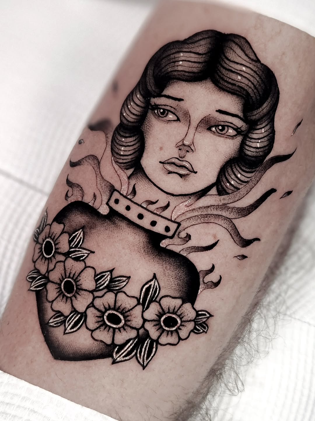 Bold blackwork portrait with blossoming floral accents