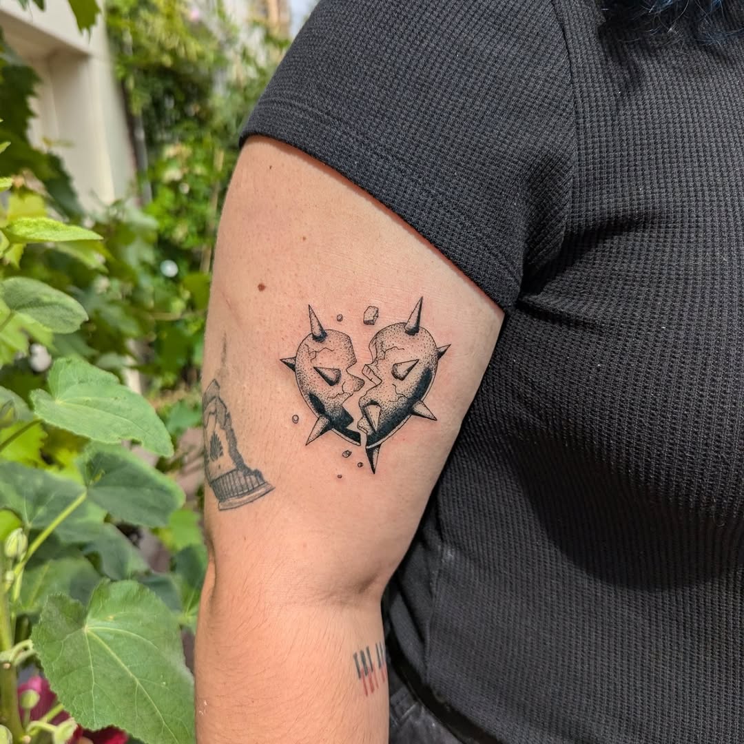 Cracked stone heart with spikes, bold blackwork shading.