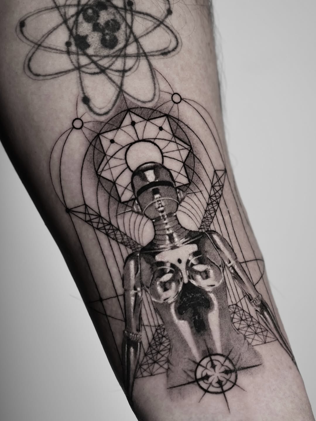 Geometric humanoid figure with orbital rings and dotwork